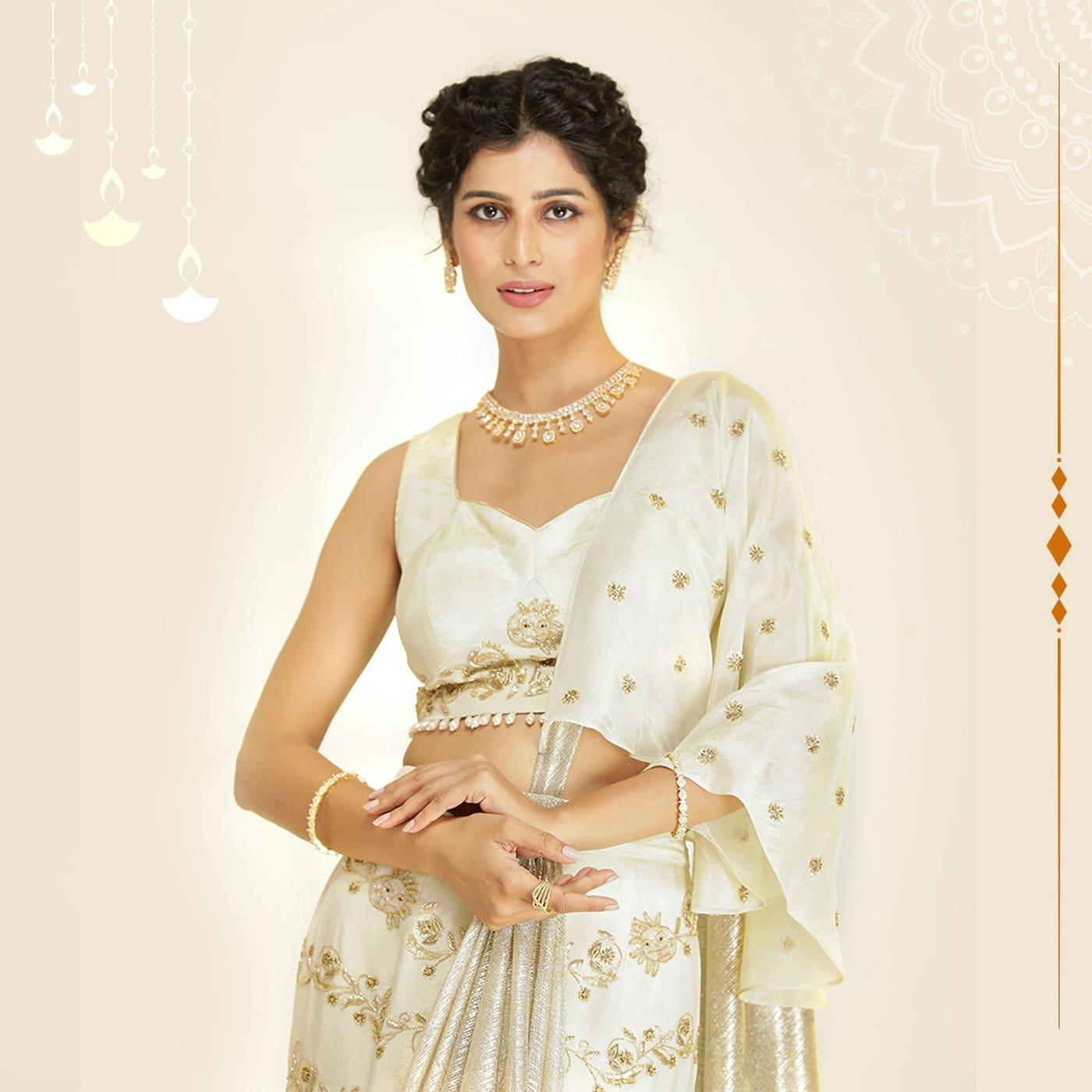 Woman in an ivory pearl-embellished lehenga and blouse