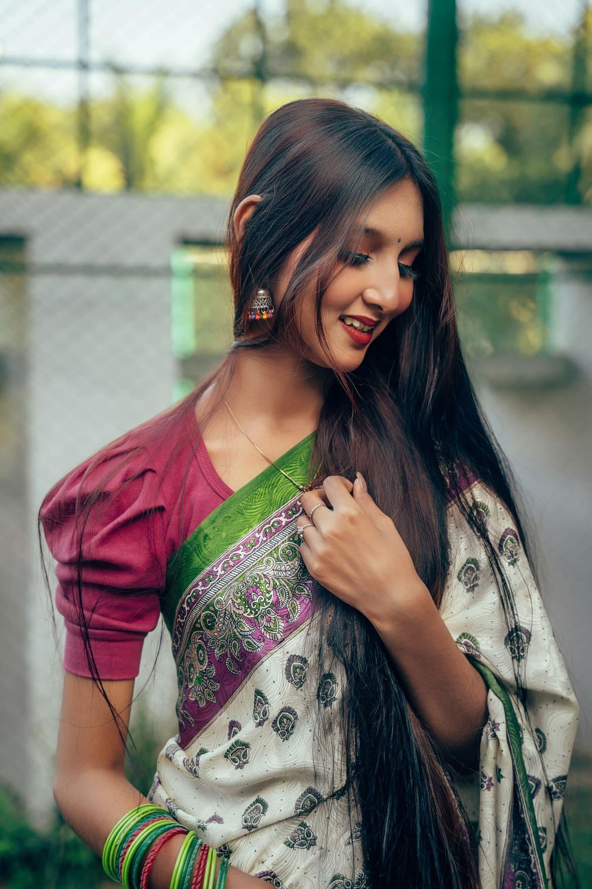 Woman wearing a magenta puff-sleeve blouse with a silk saree
