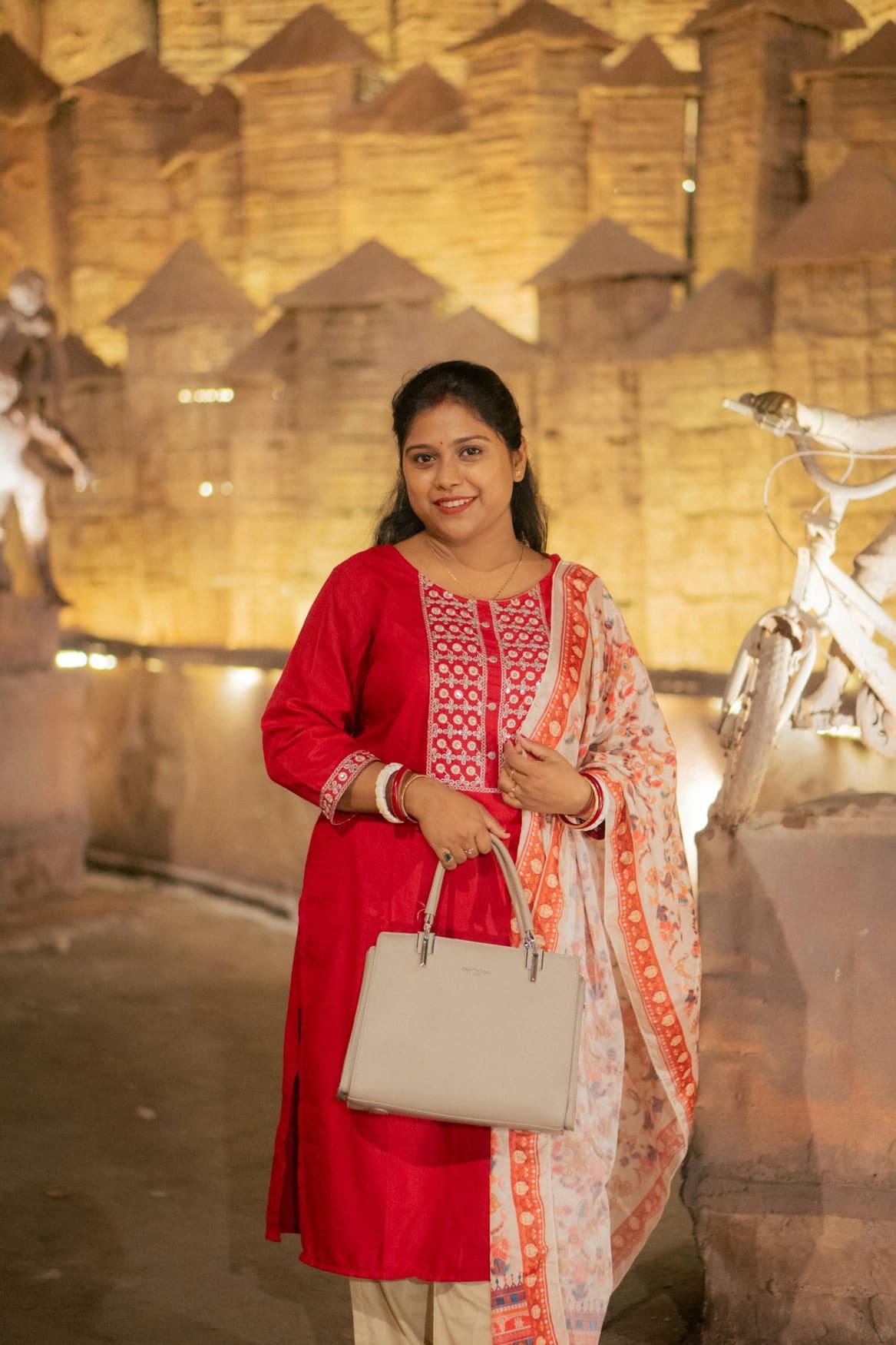 Woman in a red embroidered kurta with a printed dupatta